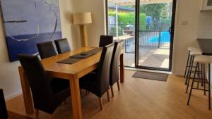 a dining room table and chairs with a view of a pool at Much More Than You Expect in Hawks Nest