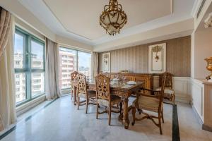 a dining room with a table and chairs and a chandelier at Nabeel Homes - Four Seasons City View Residence in Alexandria +78 photos