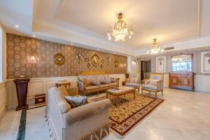 a large living room with couches and a chandelier at Nabeel Homes - Four Seasons City View Residence in Alexandria