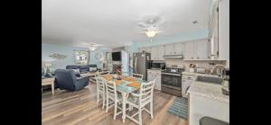 a kitchen with a table and chairs in a room at Crescent Palm North Myrtle Beach in Myrtle Beach