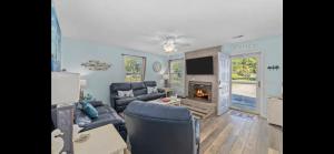 a living room with a couch and a fireplace at Crescent Palm North Myrtle Beach in Myrtle Beach