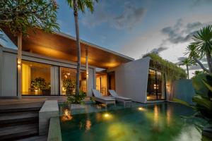 a swimming pool in the backyard of a house at INSPIRA Seminyak in Seminyak
