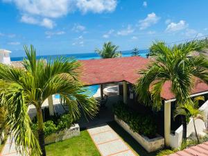 - Vistas a una casa con palmeras y al océano en Costa del mare paradiso, 