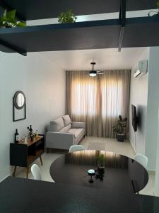 a living room with a couch and a table at Belo Apartmento Bosque da Saúde in Cuiabá