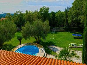 a view of a yard with a swimming pool at Villa in Čilipi near Dubrovnik with Pool in Čilipi +38 photos