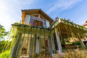 an old house with flowers on the front of it at BoHo Bingin Beach Bali in Uluwatu