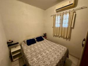 a small bedroom with a bed and a window at Casa 01 simples e aconchegante em Maragogi in Maragogi
