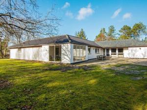 a white house with a large yard at 18 person holiday home in Rømø in Kongsmark