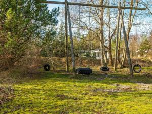 an empty playground with tires on the grass at 18 person holiday home in Rømø in Kongsmark