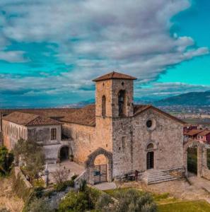 a large stone building with a tower on a hill at Loft dei Ciclopi Ferentino in Ferentino