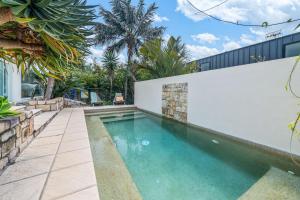 a swimming pool in the backyard of a house at 'Pandandus Rise' 1-9 Avocet Parade in Peregian Beach