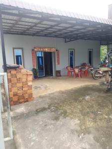 a house with a patio with tables and chairs at Homestay Srey Mom in Kampot