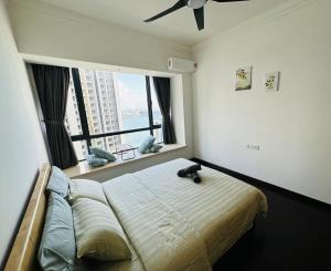 a bedroom with a large bed with a large window at Mahogany Homes at R&F - free WiFi and 1 Car Park in Johor Bahru