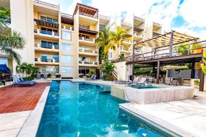 a swimming pool in front of a building at Spacious Pool Side Condo - SJD in San José del Cabo