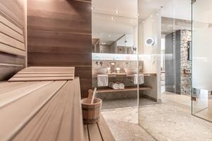 a bathroom with a shower and a sink at Superior Hotel Edelweiss in Obertauern