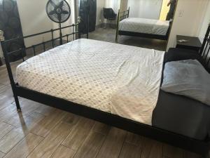 a bed in a room with a bed frame at The Vibe in Los Angeles