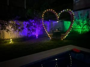 a garden with lights in the shape of a heart at Qafqaz Mountside Chalet in Gabala
