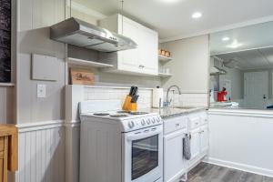 a kitchen with white cabinets and a stove top oven at 4833 Caboose Lane NW Acworth in Kennesaw +13 photos