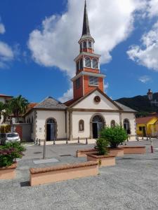a church with a steeple on top of it at Martinique 3 ILETS POINTE DU BOUT T2 35M2 in Les Trois-Îlets +7 photos