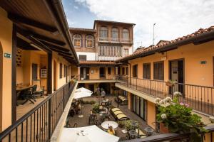 an apartment balcony with tables and chairs and buildings at Cavallo Bianco in Chivasso