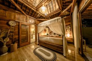 a bedroom with a bed in a wooden room at Sunsura Villas in Nusa Penida