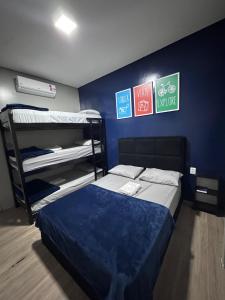 a bedroom with bunk beds and signs on the wall at On Park Hotel e Traslado in Guarulhos