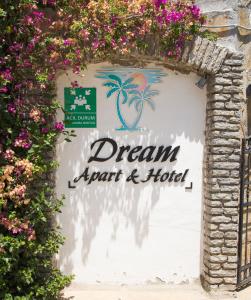 a sign for a dream spa and hotel with flowers at Dream Apart Bitez in Bitez
