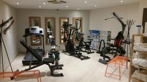 a gym with several treadmills and exercise bikes at Green hotels Confort Paris 13 in Paris