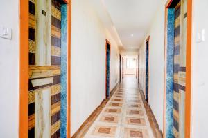 a corridor of a house with wooden shelves at Super Hotel O Kharbao Bhiwandi Thane in Bhiwandi