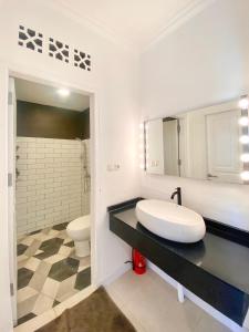 a bathroom with a sink and a toilet at Villa Eldorado By The Villas 100 in Cisarua