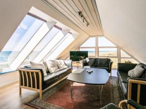 a living room with a couch and a table at 12 person holiday home in Hirtshals-By Traum in Hirtshals
