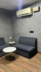 a living room with a couch and a table at Sk homes in Zirakpur