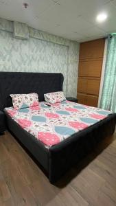 a bedroom with a bed with a quilt on it at Sk homes in Zirakpur