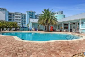 a swimming pool in front of a building at Cape Crossing 103 in Merritt Island
