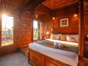 a bedroom with a large bed with wooden walls at Moustache Houseboat Srinagar in Srinagar