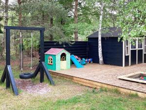a playground with a slide and a play structure at Luxury Beach House Marielyst - By Traum Ferienwohnungen in Marielyst