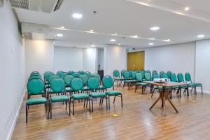 a conference room with green chairs and tables at Holiday Inn - Goiania by IHG in Goiânia +140 photos