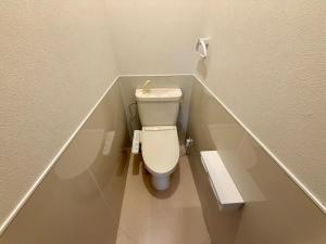 a small bathroom with a toilet in a stall at Satsuki Apartment Hotel - Koguchi Area in Shingu +10 photos