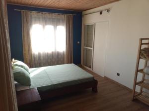 a bedroom with a bed and a window at Rosaria in Antananarivo +3 photos