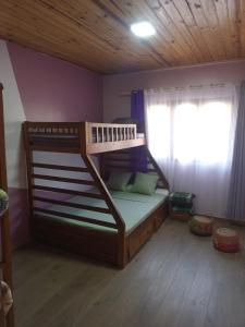 a bunk bed in a room with a window at Rosaria in Antananarivo