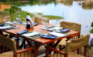 a table with chairs and a table cloth on it at Cinnamon Wild Yala in Yala