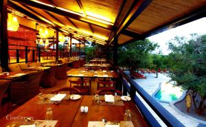 
a dining area with tables and chairs and umbrellas at Cinnamon Wild Yala in Yala
