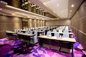a large banquet hall with tables and white chairs at Vouk Hotel Suites, Penang in George Town +44 photos