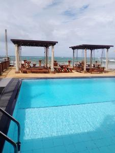 a swimming pool with a view of the ocean at Rock Fort Beach Resort in Unawatuna