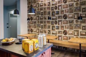 a restaurant with a wall of pictures on the wall at Alla Meta in Mogliano Veneto