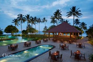 a view of a resort with a pool and a restaurant at Hikka Tranz by Cinnamon in Hikkaduwa