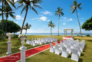 a wedding ceremony on the beach with white chairs and a altar at Hikka Tranz by Cinnamon in Hikkaduwa