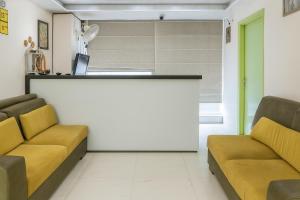 a waiting room with two couches and a counter at Comfort Stay - Near Airport in Lucknow