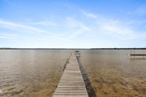 un muelle en medio de una masa de agua en 11 Family Lakefront Studios on Lake Missaukee - Sleeps 40, en Lake City