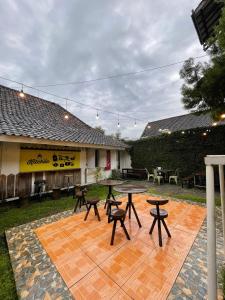 a patio with a table and chairs and a building at Pi Home by Perwira Hub in Yogyakarta +1 photo